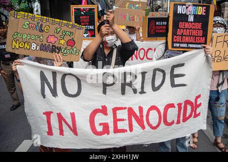 Participants hold a banner and placards expressing their opinions during the demonstration. The Non-Binary activists and supporters gathered at the Ratchaprasong Intersection before marching along the road to mark The International Non-Binary People's day in Bangkok and calling for the equal rights of all genders. (Photo by Peerapon Boonyakiat / SOPA Images/Sipa USA) Stock Photo