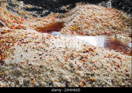 traditional oriental dish Uzbek rice pilaf with spices in a large cauldron in kitchen in Central Asian pilaf center in Tashkent in Uzbekistan close-up Stock Photo