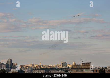 Kyiv, Ukraine - August 22, 2021: Aerial summer cityscape with flying military airplanes during parade dedicated to Independence Day of Ukraine. Stock Photo