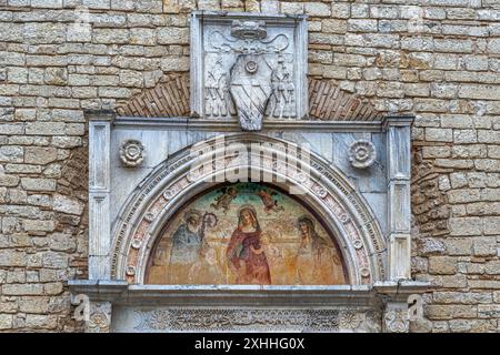 The fresco of the entrance portal of the Abbey of Farfa. It represents the Madonna crowned with Saint Benedict and Saint Scholastica.Lazio Stock Photo