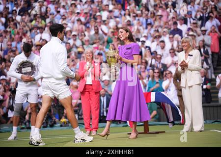 LONDON, ENGLAND - JULY 14: Catherine Princess of Wales presents the winner's trophy to Spain's Carlos Alcaraz (L) after beating Serbia's Novak Djokovic during their men's singles final tennis match on day fourteen of the Wimbledon Tennis Championships at the All England Lawn Tennis and Croquet Club on July 14, 2024 in London, England Credit: MB Media Solutions/Alamy Live News Stock Photo