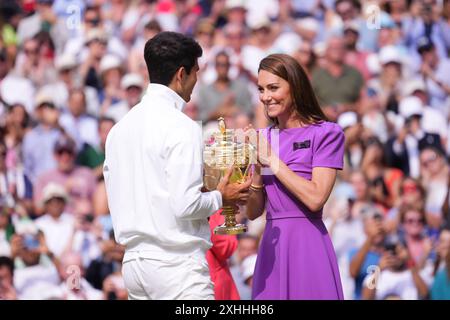 LONDON, ENGLAND - JULY 14: Catherine Princess of Wales presents the winner's trophy to Spain's Carlos Alcaraz (L) after beating Serbia's Novak Djokovic during their men's singles final tennis match on day fourteen of the Wimbledon Tennis Championships at the All England Lawn Tennis and Croquet Club on July 14, 2024 in London, England Credit: MB Media Solutions/Alamy Live News Stock Photo