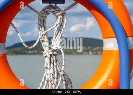 An orange life jacket on the railing of a port in Balaton Stock Photo