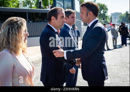 Paris, France. 14th July, 2024. French Secretary of State for Veterans and Memory Patricia Miralles, French Armies Minister Sebastien Lecornu, French Prime Minister Gabriel Attal and French President Emmanuel Macron attending the Bastille Day parade along the Avenue Foch at place Marechal de Lattre de Tassigny, in Paris, France on July 14, 2024. Photo by Eric Tschaen/Pool/ABACAPRESS.COM Credit: Abaca Press/Alamy Live News Stock Photo