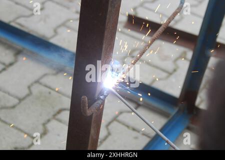 Welding man working on iron welding in construction site. Close up. Stock Photo
