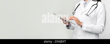 Unrecognizable Doctor Using Digital Tablet On White Stock Photo