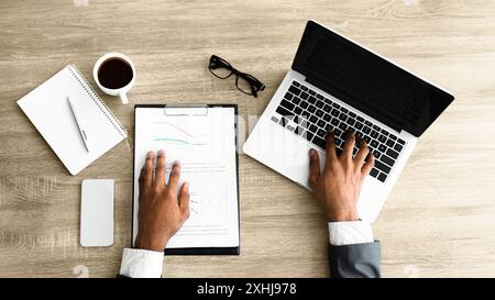 Businessman Working on Laptop and Documents Stock Photo