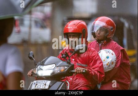 Mumbai, India. 14th July, 2024. MUMBAI, INDIA - JULY 14: People going through the rain at Powai, on July 14, 2024 in Mumbai, India. (Photo by Satish Bate/Hindustan Times/Sipa USA ) Credit: Sipa USA/Alamy Live News Stock Photo