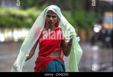 Mumbai, India. 14th July, 2024. MUMBAI, INDIA - JULY 14: People going through the rain at Powai, on July 14, 2024 in Mumbai, India. (Photo by Satish Bate/Hindustan Times/Sipa USA ) Credit: Sipa USA/Alamy Live News Stock Photo