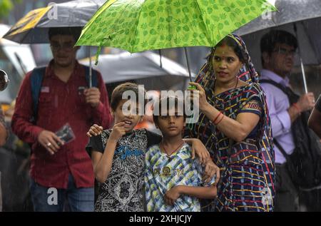 Mumbai, India. 14th July, 2024. MUMBAI, INDIA - JULY 14: People going through the rain at Powai, on July 14, 2024 in Mumbai, India. (Photo by Satish Bate/Hindustan Times/Sipa USA ) Credit: Sipa USA/Alamy Live News Stock Photo