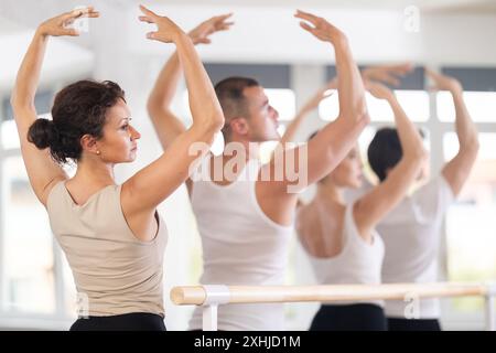 Rear view of female ballet student practicing arm positions in studio Stock Photo