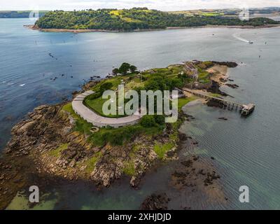 Aerial view of Drake's Island in Plymouth Sound, featuring lush greenery, historic buildings, and rocky shores. Stock Photo