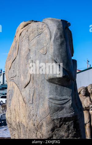 Stone carving of a face at Inuit sculpture park by the Four Corners in Iqaluit, Nunavut, Canada Stock Photo