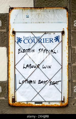 Newspaper billboard in North Berwick, East Lothian, Scotland, UK - Election Special - Labour win Lothian East seat - Douglas Alexander. Stock Photo