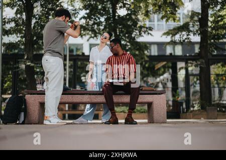 Group of young professionals collaborating in outdoor setting, sharing ideas, and discussing work over lunch break Stock Photo