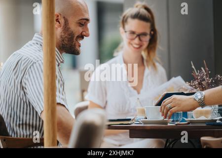 Startup team in a business meeting discussing and strategizing outdoors over coffee Stock Photo