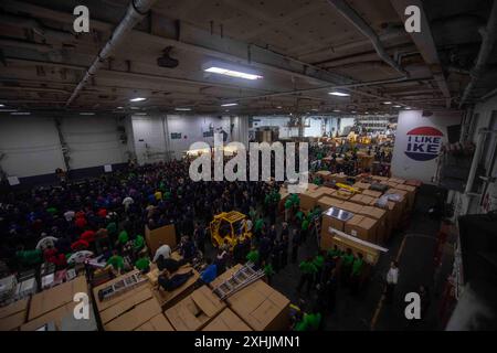 240713-N-EY390-1024 ATLANTIC OCEAN (July 13, 2024) Sailors gather in the hangar bay for an all hands call aboard the aircraft carrier USS Dwight D. Eisenhower (CVN 69) July 13, 2024. Dwight D. Eisenhower is operating in the Atlantic Ocean in support of U.S. 2nd Fleet to maintain maritime stability and security, ensure access, deter aggression and defend U.S., Allied and partner interests. (U.S. Navy photo by Mass Communication Mass Communication Specialist 2nd Class Kade Base) Stock Photo