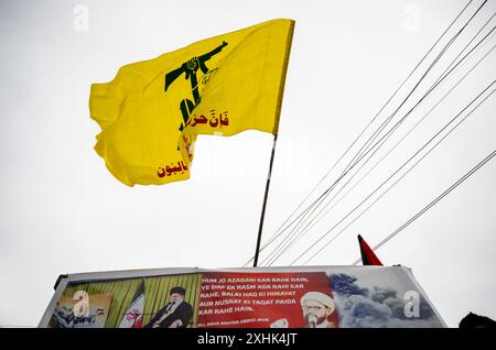 A Kashmiri Shia Muslim man waves a religious flag during a Muharram ...