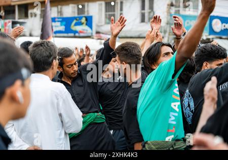 Srinagar, India. 14th July, 2024. A Kashmiri Shia Muslim man waves a ...