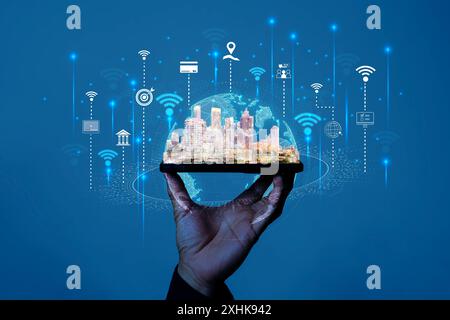 Smart city and Internet of things (IOT) on smartphone in hand, objects icon connecting together, Internet networking concept with background modern ci Stock Photo
