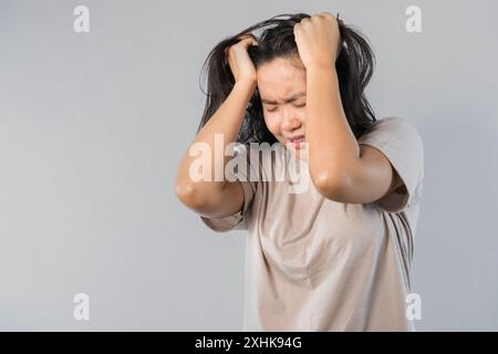 Young asian beautiful woman hand touching head she's feeling depressed stress headache be tired from working standing on isolated white background she Stock Photo