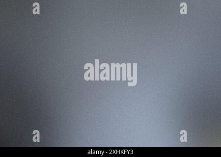 Gradient of grey tones on a brushed metal texture background, transitioning from dark to light Stock Photo
