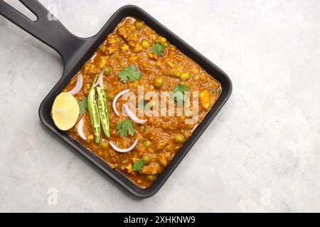 Indian famous dish Mutton matar Kheema Pav or Khima Paav is a minced goat meat curry. Mutton keema is cooked with onion, tomatoes, potatoes. Stock Photo