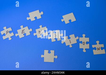 Pieces of a jigsaw puzzle spelling out the word Pension, puzzle of pensions, puzzling pension Stock Photo