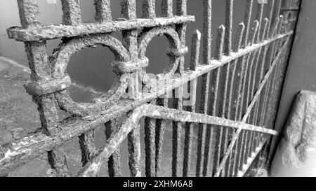 A rusty big old iron gate in a city lane Stock Photo