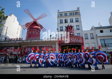 Paris, France. 15th July, 2024. Dancers from the Moulin Rouge cabaret perform in the street during the Olympic torch relay in Paris, on July 15, 2024, ahead of the Paris 2024 Olympic and Paralympic Games. Photo by Eliot Blondet/ABACAPRESS.COM Credit: Abaca Press/Alamy Live News Stock Photo