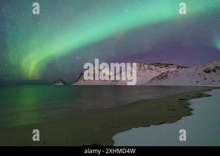 Northern Lights over the snowy Haukland beach, Lofoten Islands, Norway Stock Photo