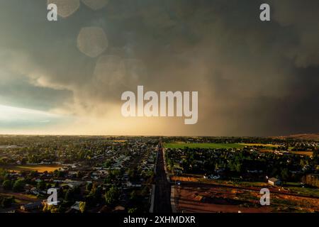 Dramatic storm clouds sweep across the sky at sunset. Stock Photo