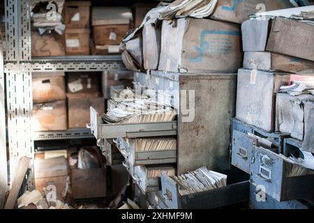 Abandoned archive room with open, rusty file cabinets Stock Photo