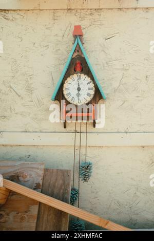 Vintage cuckoo clock on textured wall. Stock Photo