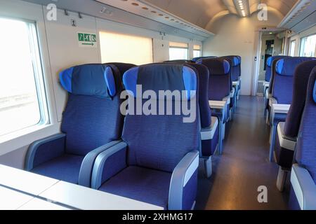 Empty modern train with blue seats waiting at the station for passengers to board Stock Photo