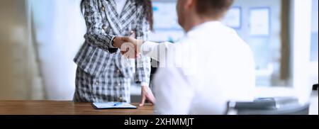 Business partners shaking hands after making good deal Stock Photo