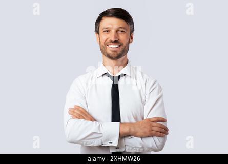 Business Guy Smiling Crossing Hands Standing Over White Background Stock Photo
