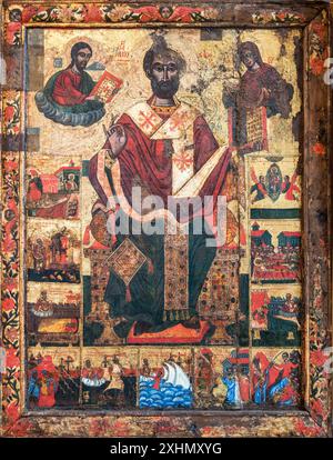 Greek icon of Saint Nicolas, depicting scenes from his life. Painted on wooden board, 17th century. Mani, Southern Peloponnese, Greece. Stock Photo