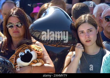 VINNYTSIA, UKRAINE - JULY 14, 2024 - People pay tribute to the victims of the Russian missile strike on downtown Vinnytsia on July 14, 2022, at the ‘To the Victims of Missile Attacks on Vinnytsia’ memorial in Peremohy Square, Vinnytsia, west-central Ukraine. Twenty-nine people, including three children, were killed by the attack. Stock Photo