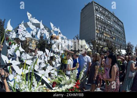 VINNYTSIA, UKRAINE - JULY 14, 2024 - People pay tribute to the victims of the Russian missile strike on downtown Vinnytsia on July 14, 2022, at the ‘To the Victims of Missile Attacks on Vinnytsia’ memorial in Peremohy Square, Vinnytsia, west-central Ukraine. Twenty-nine people, including three children, were killed by the attack. Stock Photo