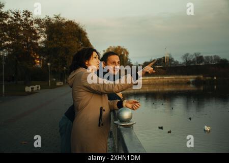 a married couple walks along the embankment, spending time together. Stock Photo