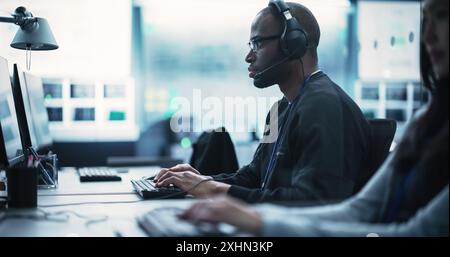 African American Computer Engineer Finds and Fixes Bugs in a Product or Program Before the Launch. Young Black Specialist Working in Advanced Technology Industry Stock Photo