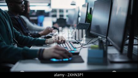 Close Up Specialist Working on Computer, Programming a Software for an Innovative Technological Internet Product Launch. Diverse Multicultural Team Working in a Startup Agency Stock Photo