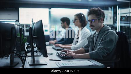 Portrait of a Focused Computer Engineer Working in a Technological Office Facility. Research and Development Department Writing Software Code for an Innovative Online Program for a Global Enterprise Stock Photo