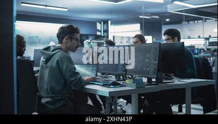 Team of Diverse Multiethnic Software Developers Working on Computers, Programming Advanced Code, Managing Artificial Intelligence Projects Online for Innovative Cyber Security Service Stock Photo