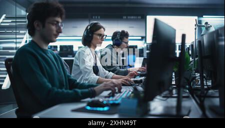 Team of Diverse Multiethnic Software Developers Working on Computers, Developing Artificial Intelligence Projects. Specialist Putting On Headphones. Focus Switching to Another Creative Colleague Stock Photo