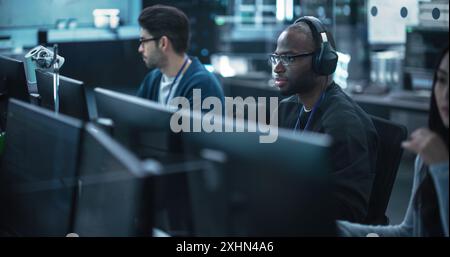 African American Computer Engineer Finds and Fixes Bugs in a Product or Program Before the Launch. Young Black Specialist Working in Advanced Technology Industry Stock Photo