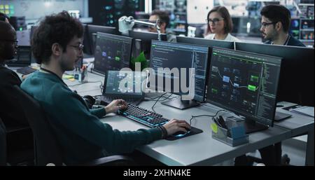 Team of Diverse Multiethnic Software Developers Working on Computers, Programming Advanced Code, Managing Artificial Intelligence Projects Online for Innovative Cybersecurity Technology Company Stock Photo