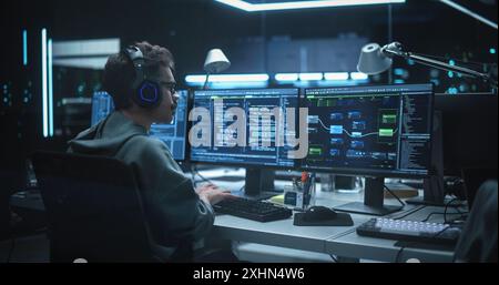 Young Hacker Working Alone, Hacking Corporate Data Servers From His Underground Hideout. Hacktivist Organizes a Massive Data Breach Cyber Attack, Hiding His Identity Behind Multiple Proxy Servers Stock Photo