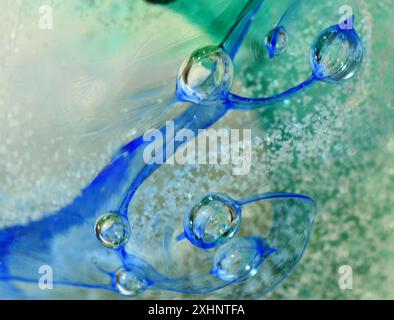 Bubbles and colours in glass blue and green background. Stock Photo